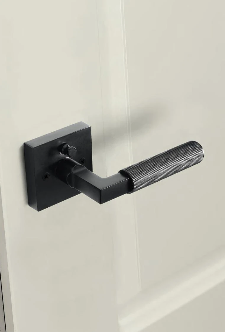 Sculptural door lever on a light interior door